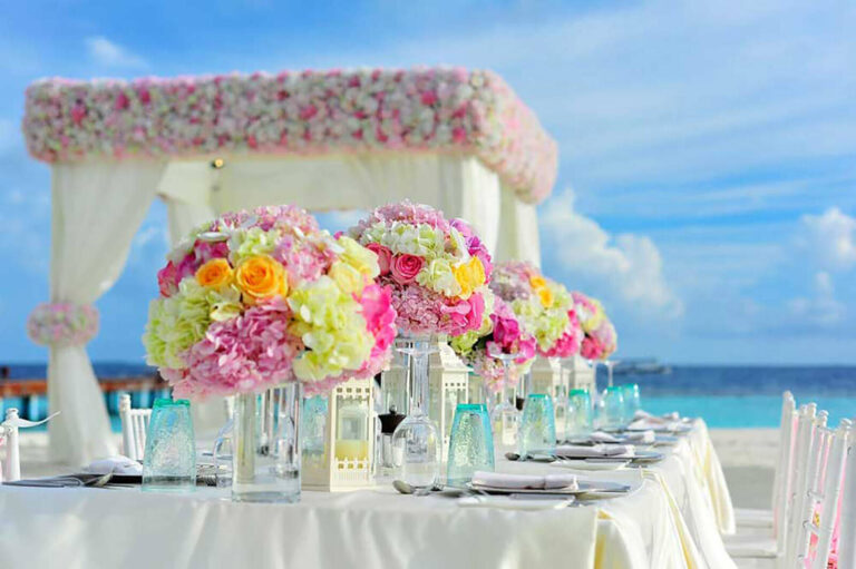flowers on dining table for beach wedding reception event