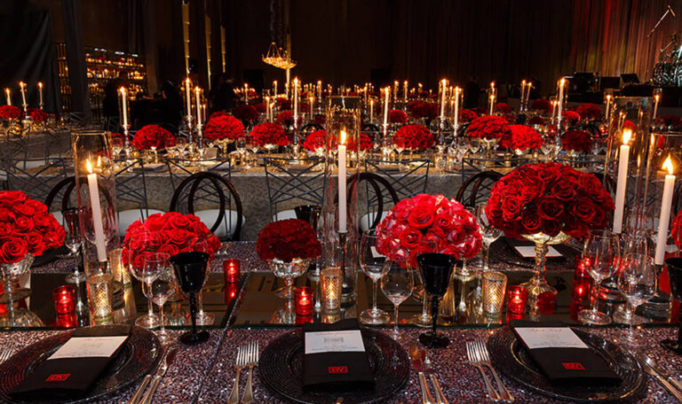 Red roses on long dinner tables at an 80th birthday party diner private celebration event