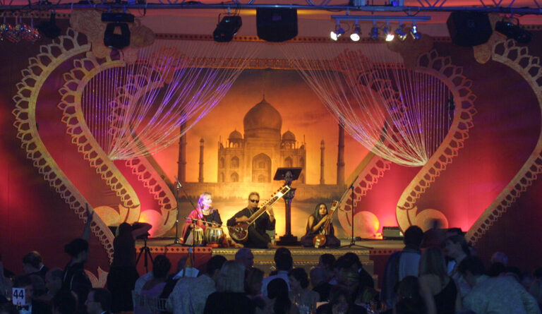 Taj Mahal backdrop and Indian musicians on stage at at British Red Cross London Ball Indian themed fundraising event