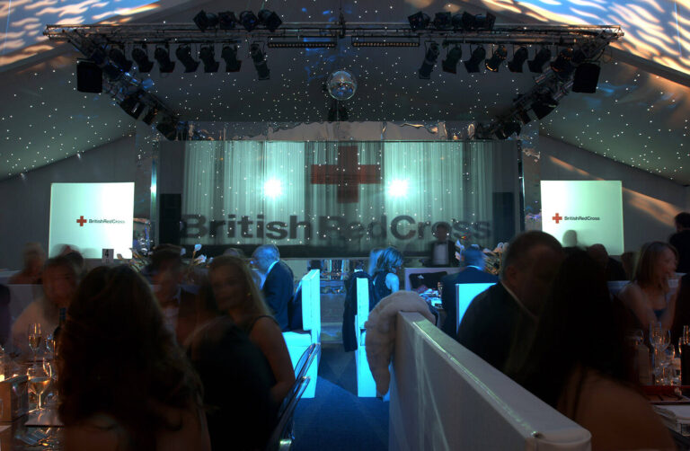 Water curtain in front of stage with British Red Cross logo projected onto it at at British Red Cross London Ball water themed fundraising event