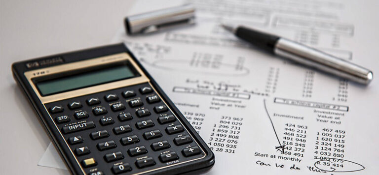 budget spreadsheets, calculator and pen