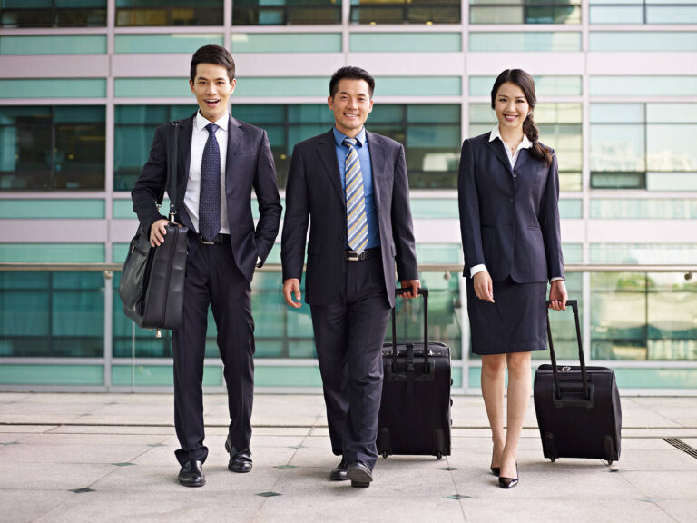 asian business people with luggage
