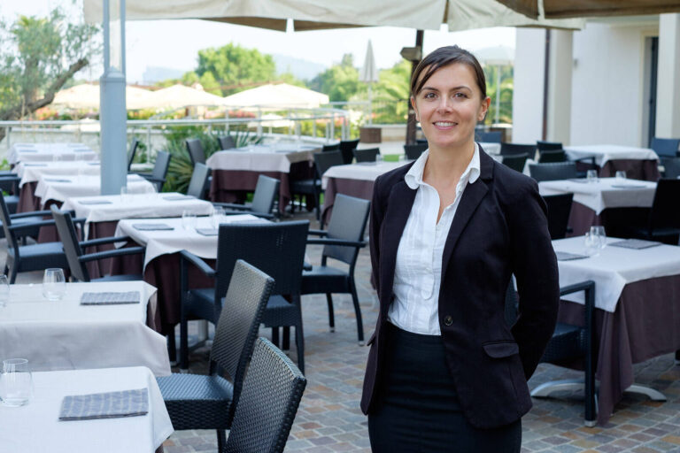 catering event planner standing next to dining tables