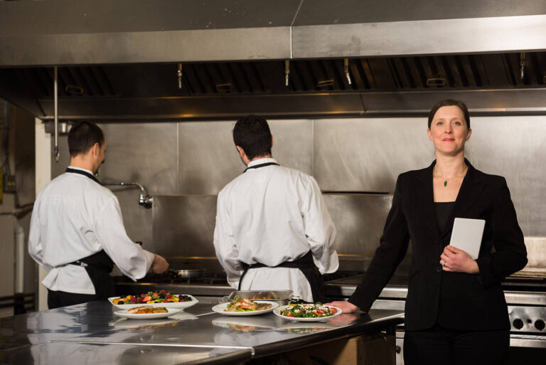 catering event planner and chefs in kitchen