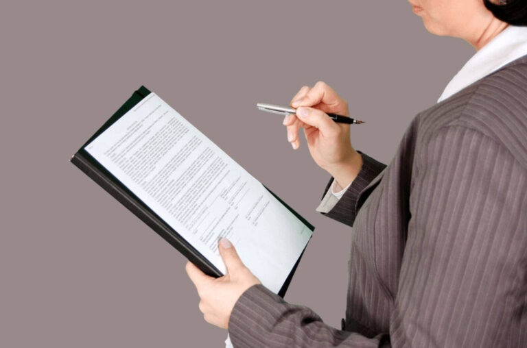 corporate event planner reading contract with a pen