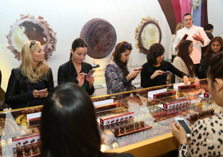 group of women tasting chocolate truffles at the Godiva #TruffleTakeoff Tours experiential marketing event