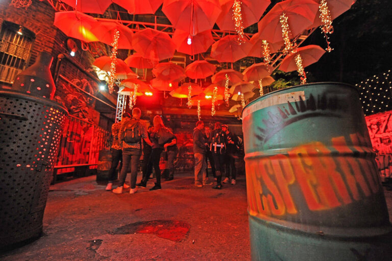 red umbrellas suspended over the heads of party guests at Heineken Desperados experiential marketing event