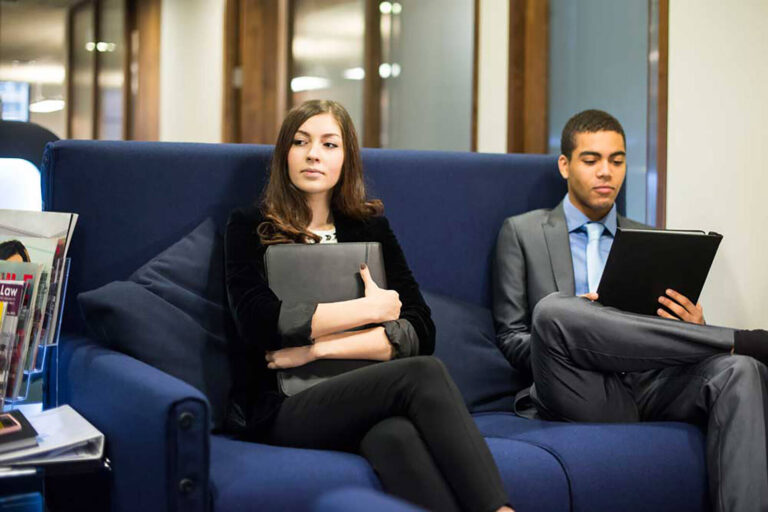 male and female job candidates waiting for their interviews