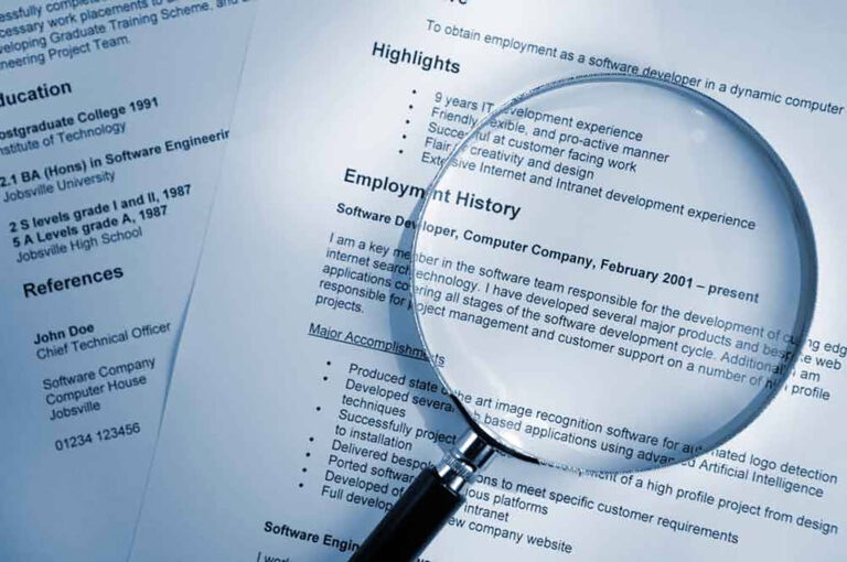 magnifying glass held over the employment history section of a resume