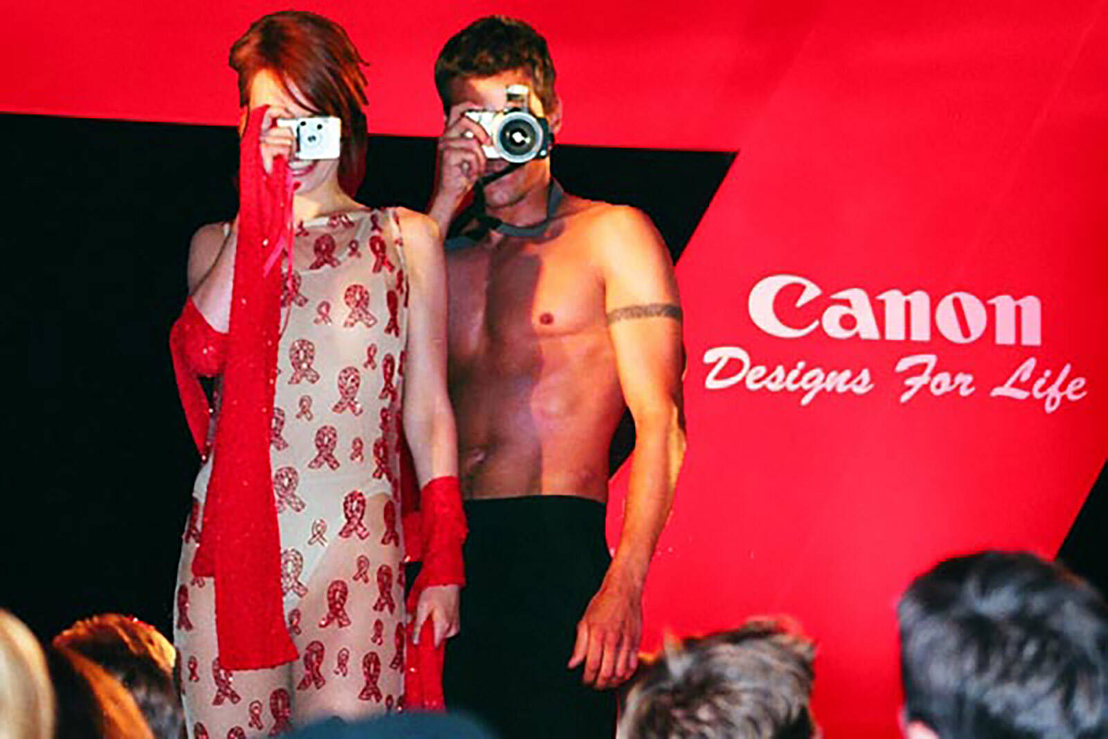 models photographing the audience at Canon Designs for Life AIDS red ribbon fashion show for London Lighthouse produced by Matt James of Leftfield Productions