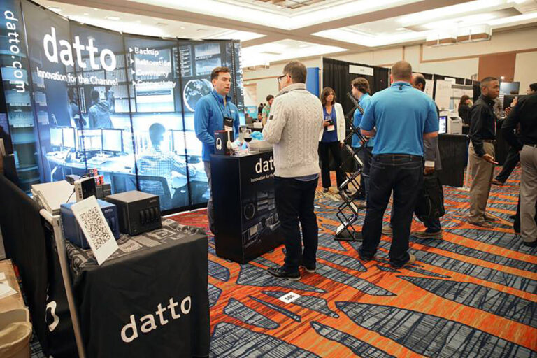 people at exhibition stands at Midsize Enterprise Summit conference