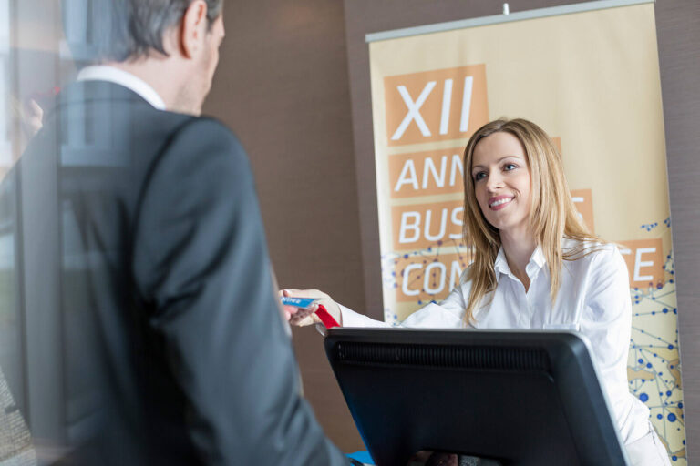 onsite event coordinator checking in guests at an event registration desk