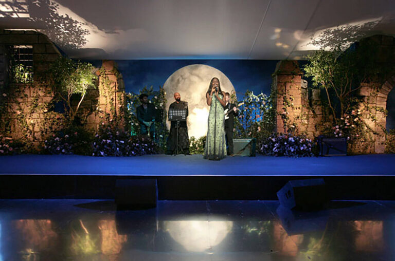 singer and band on a moonlit stage set at British Red Cross London Ball Secret Garden theme fundraising event