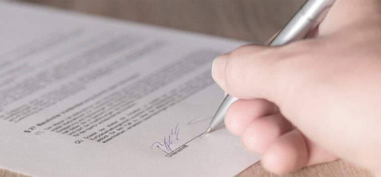hand signing an event planning contract