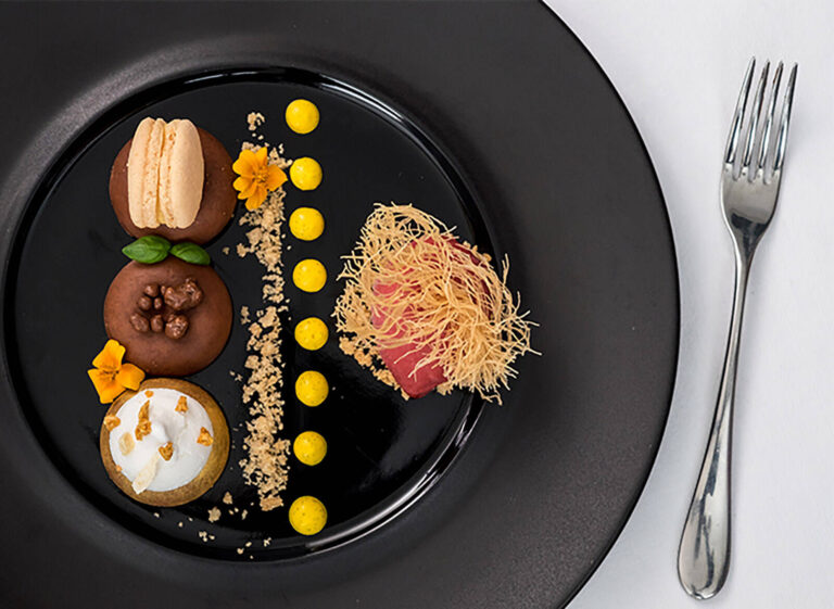 modern and stylish special event catering plated dessert on a black plate