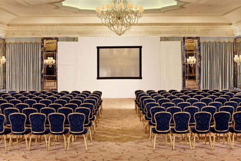 chairs set up theatre style facing a screen for a meeting at The Dorchester Hotel