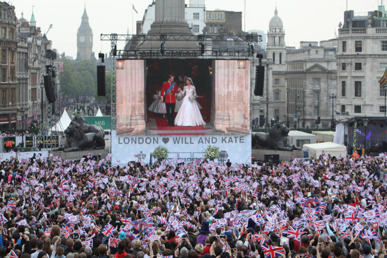 Crowd in front of large screen and stage at UK Royal Wedding public viewing celebration event Trafalgar Square London