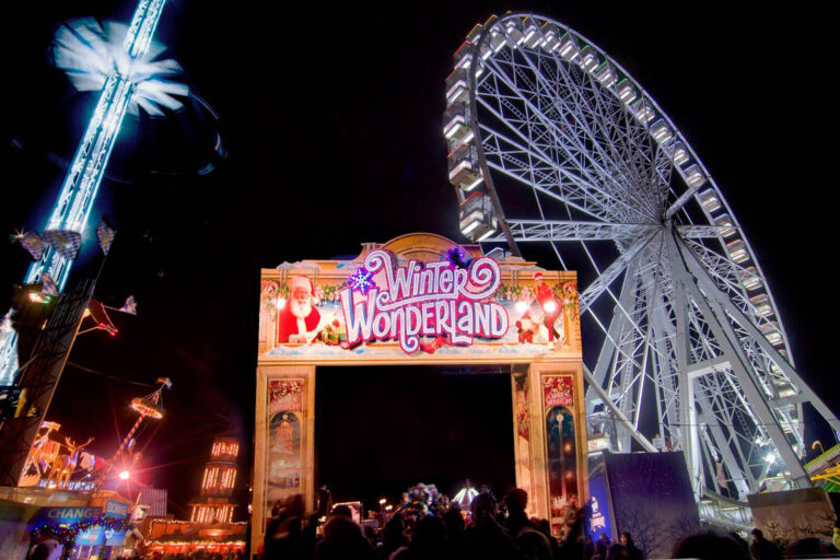 Entrance arch and big wheel at Winter Wonderland festival Hyde Park London