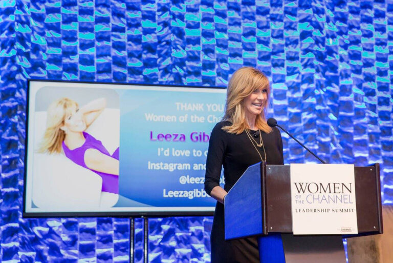 female speaker on stage at Women of the Channel Leadership Summit conference
